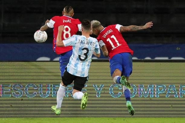Eduardo Vargas of Chile heads the ball to score the first goal of his team after teammate Arturo Vidal failed a penalty kick during a Group A match...