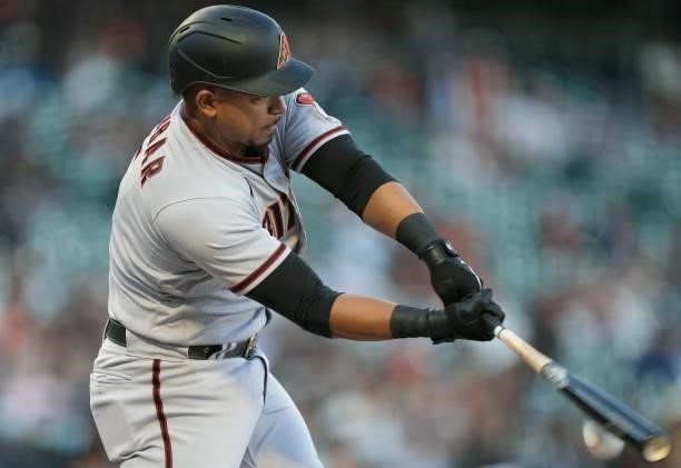 Eduardo Escobar of the Arizona Diamondbacks hits an infield single to third base against the San Francisco Giants in the top of the first inning at...