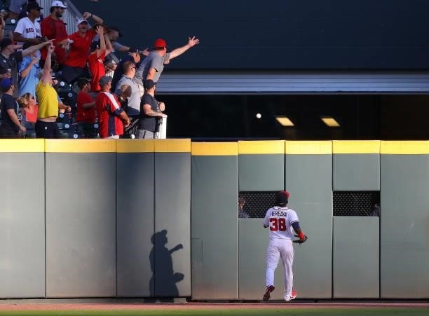 Guillermo Heredia of the Atlanta Braves watches as a three-run homer hit by Rafael Devers of the Boston Red Sox flies over the centerfield wall in...