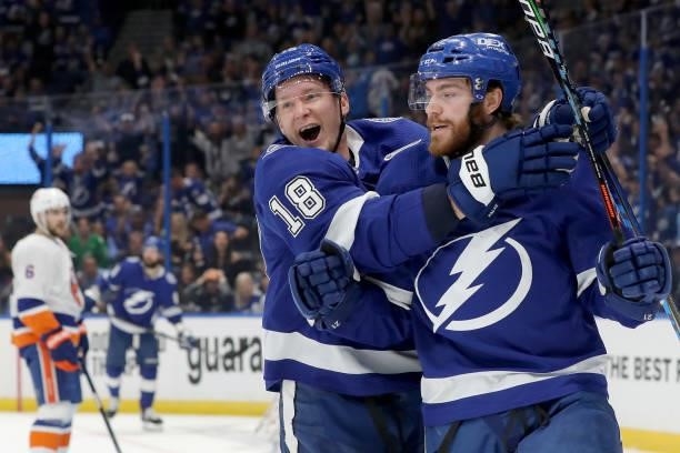 Brayden Point of the Tampa Bay Lightning celebrates with Ondrej Palat after scoring a goal on Semyon Varlamov of the New York Islanders during the...