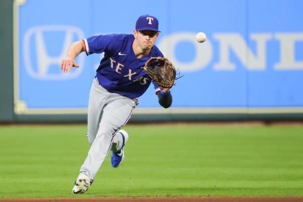 Nick Solak of the Texas Rangers fields a ground ball to throw out Jose Altuve of the Houston Astros during the first inning at Minute Maid Park on...