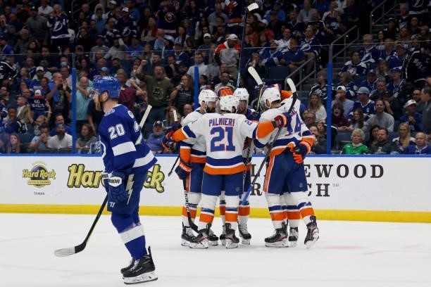 Brock Nelson of the New York Islanders celebrates with his teammates after scoring a goal on Andrei Vasilevskiy of the Tampa Bay Lightning during the...