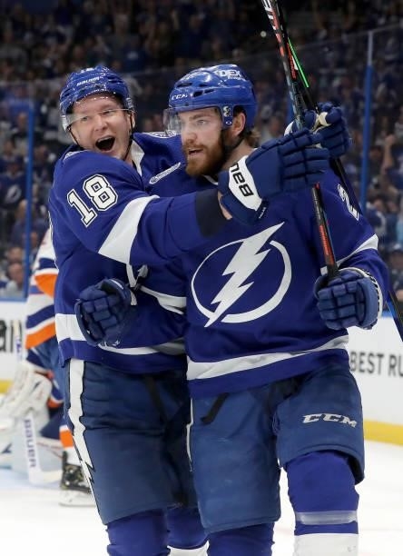Brayden Point of the Tampa Bay Lightning celebrates with Ondrej Palat after scoring a goal on Semyon Varlamov of the New York Islanders during the...