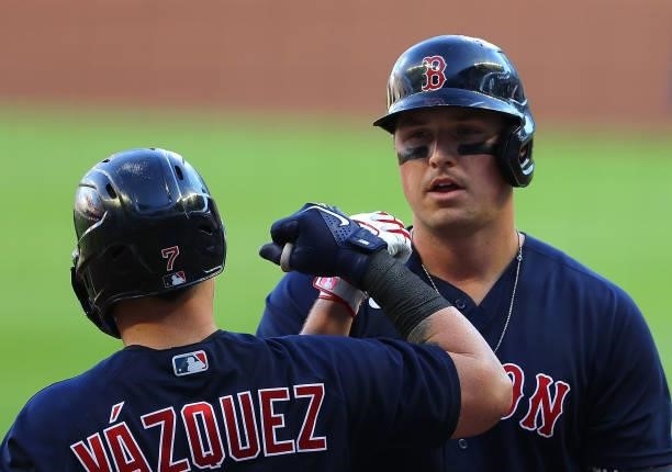 Hunter Renfroe of the Boston Red Sox reacts with Christian Vazquez after hitting a solo homer in the first inning against the Atlanta Braves at...