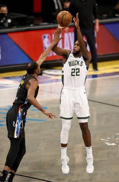 Khris Middleton of the Milwaukee Bucks takes a shot as he is fouled by Kevin Durant of the Brooklyn Nets in the first quarter during game 5 of the...