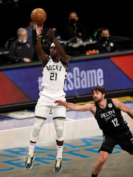 Jrue Holiday of the Milwaukee Bucks takes a shot as Joe Harris of the Brooklyn Nets defends in the first quarter during game 5 of the Eastern...