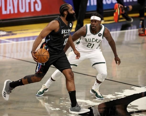 James Harden of the Brooklyn Nets drives around Jrue Holiday of the Milwaukee Bucks in the first quarter during game 5 of the Eastern Conference...