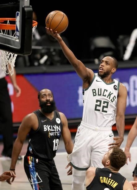 Khris Middleton of the Milwaukee Bucks heads for the net as James Harden of the Brooklyn Nets defends during game 5 of the Eastern Conference second...