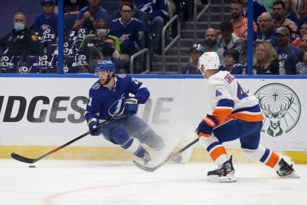 Brayden Point of the Tampa Bay Lightning skates with the puck against Andy Greene of the New York Islanders during the first period in Game Two of...