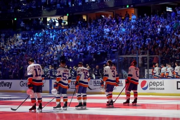 Matt Martin, Casey Cizikas, Cal Clutterbuck, Adam Pelech and Ryan Pulock of the New York Islanders stand on the ice during the national anthem prior...