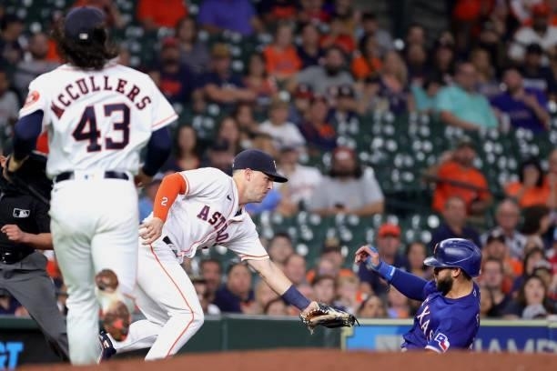 Alex Bregman of the Houston Astros tags out Joey Gallo of the Texas Rangers at third base during the fourth inning at Minute Maid Park on June 15,...