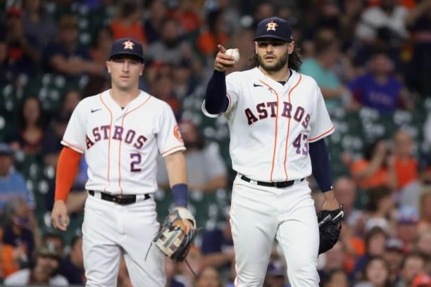 Lance McCullers Jr. #43 of the Houston Astros gestures towards the dugout alongside Alex Bregman during the fourth inning against the Texas Rangers...