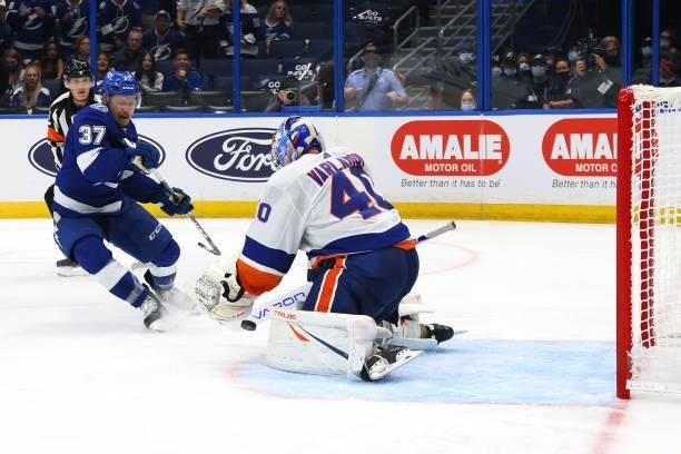 Semyon Varlamov of the New York Islanders makes a save against Yanni Gourde of the Tampa Bay Lightning during the second period in Game Two of the...