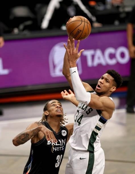 Giannis Antetokounmpo of the Milwaukee Bucks heads for the net as Nicolas Claxton of the Brooklyn Nets defends during game 5 of the Eastern...