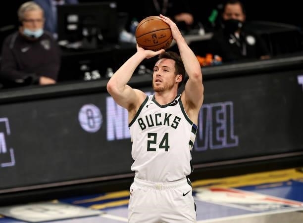 Pat Connaughton of the Milwaukee Bucks shoots a three point shot in the first half against the Brooklyn Nets during game 5 of the Eastern Conference...
