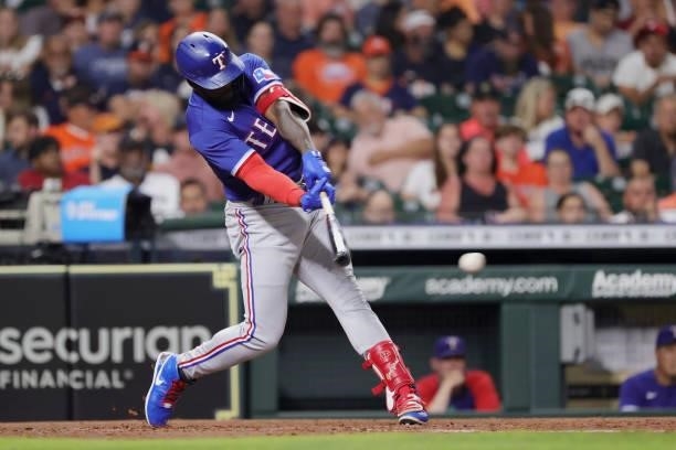 Adolis Garcia of the Texas Rangers reaches first base on a fielders choice during the fifth inning against the Houston Astros at Minute Maid Park on...