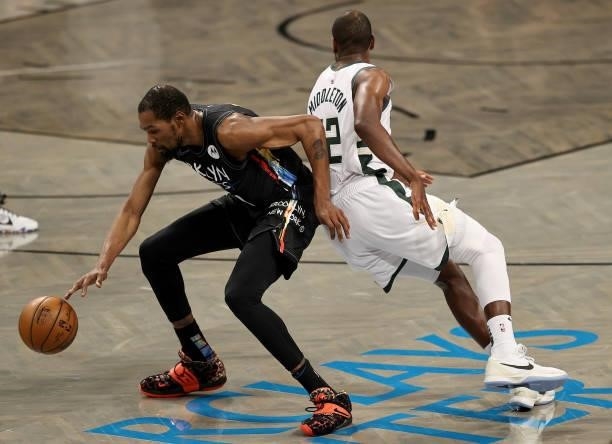 Kevin Durant of the Brooklyn Nets tries to keep the ball as Khris Middleton of the Milwaukee Bucks defends game 5 of the Eastern Conference second...