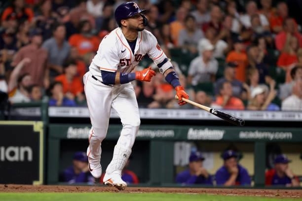 Yuli Gurriel of the Houston Astros hits a sacrifice fly during the sixth inning against the Texas Rangers at Minute Maid Park on June 15, 2021 in...