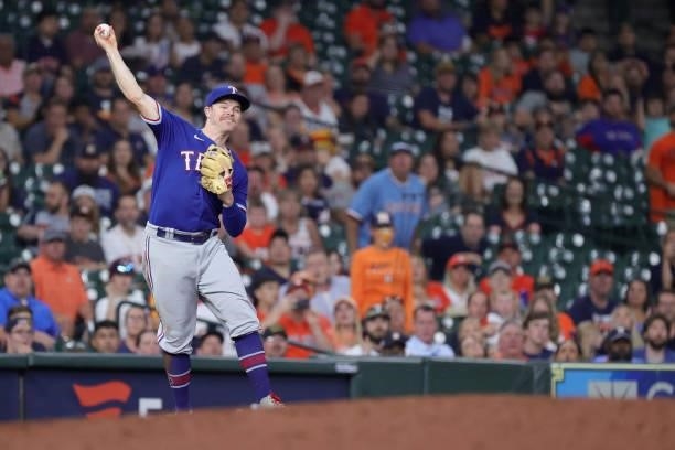 Brock Holt of the Texas Rangers throws out Alex Bregman of the Houston Astros during the sixth inning at Minute Maid Park on June 15, 2021 in...