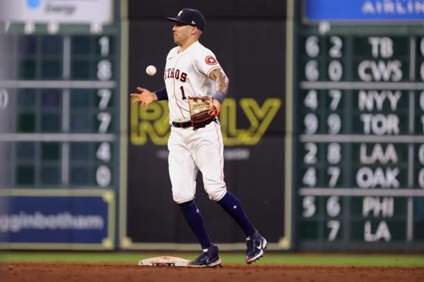 Carlos Correa of the Houston Astros is unable to make a play on a ball hit by Willie Calhoun of the Texas Rangers during the sixth inning at Minute...