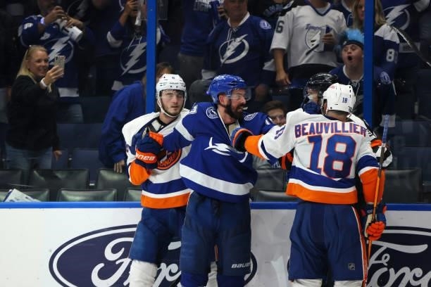 Alex Killorn of the Tampa Bay Lightning fights with Noah Dobson and Anthony Beauvillier of the New York Islanders during the third period in Game Two...