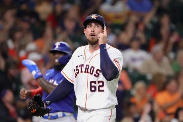 Blake Taylor of the Houston Astros gestures during the fifth inning after Michael Brantley made a catch on a ball hit by Nick Solak of the Texas...