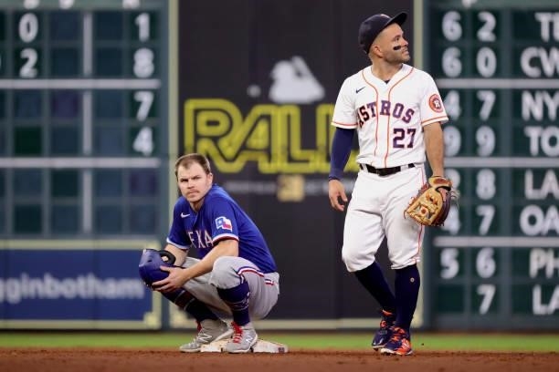 Brock Holt of the Texas Rangers waits for a call at second ahead of Jose Altuve of the Houston Astros during the fifth inning at Minute Maid Park on...