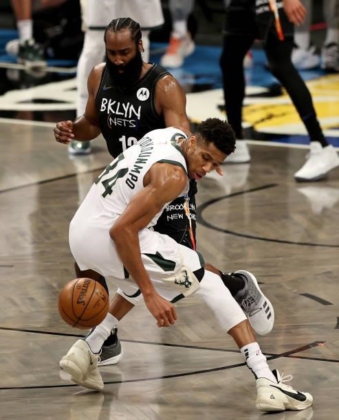 Giannis Antetokounmpo of the Milwaukee Bucks has trouble keeping the ball as James Harden of the Brooklyn Nets defends in the second half during game...