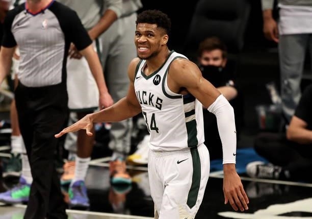 Giannis Antetokounmpo of the Milwaukee Bucks reacts after he was called for a foul in the fourth quarter against the Brooklyn Nets during game 5 of...