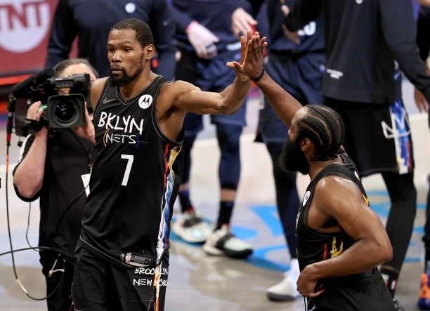 Kevin Durant and James Harden of the Brooklyn Nets celebrate the win after the game against the Milwaukee Bucks during game 5 of the Eastern...