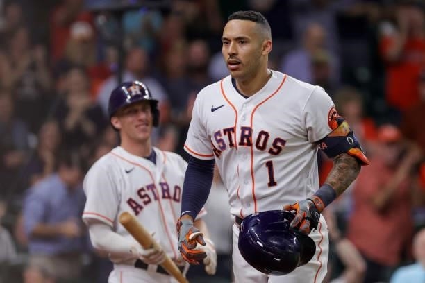 Carlos Correa of the Houston Astros reacts after hitting a solo home run during the ninth inning to force extra innings against the Texas Rangers at...