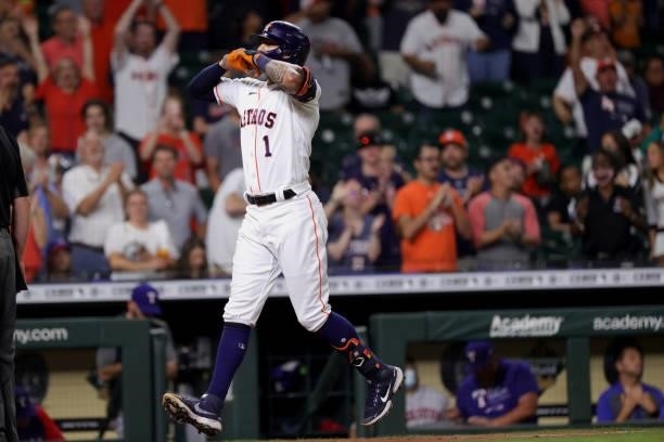 Carlos Correa of the Houston Astros hits a solo home run during the ninth inning to force extra innings against the Texas Rangers at Minute Maid Park...