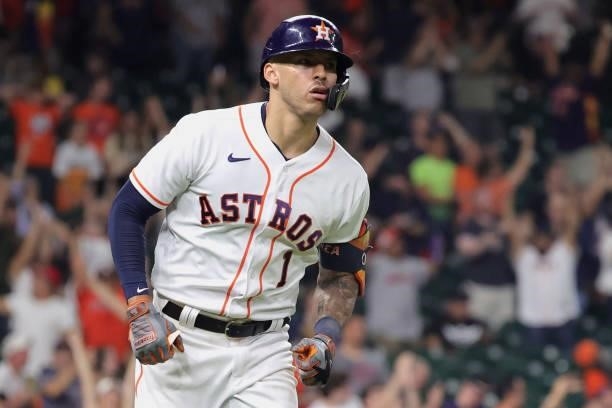 Carlos Correa of the Houston Astros runs the bases after hitting a solo home run during the ninth inning to force extra innings against the Texas...