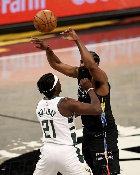 James Harden of the Brooklyn Nets passes the ball as Jrue Holiday of the Milwaukee Bucks defends during game 5 of the Eastern Conference second round...