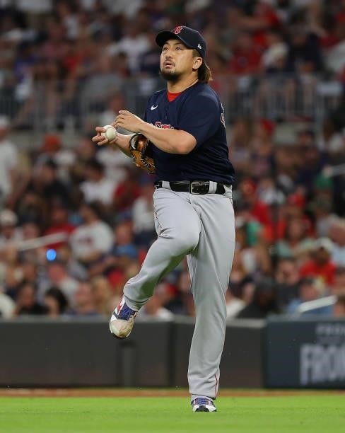 Hirokazu Sawamura of the Boston Red Sox stretches after an out in the seventh inning against the Atlanta Braves at Truist Park on June 15, 2021 in...