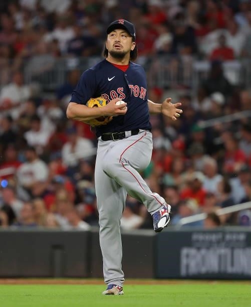 Hirokazu Sawamura of the Boston Red Sox stretches after an out in the seventh inning against the Atlanta Braves at Truist Park on June 15, 2021 in...