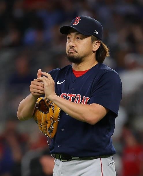Hirokazu Sawamura of the Boston Red Sox cleans the ball between pitches in the seventh inning against the Atlanta Braves at Truist Park on June 15,...