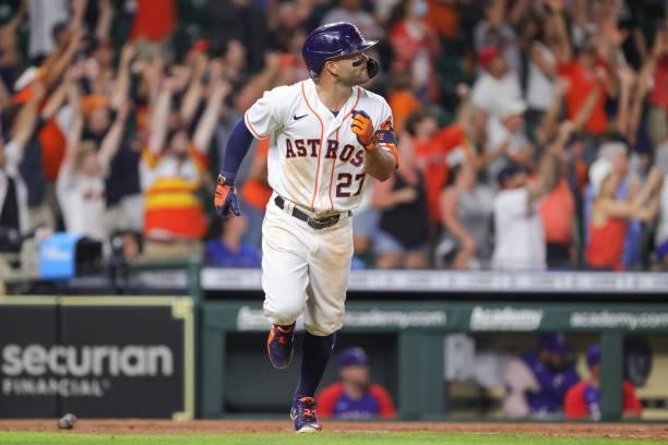Jose Altuve of the Houston Astros watches his grand slam to defeat the Texas Rangers during the tenth inning by a score of 6-3 at Minute Maid Park on...