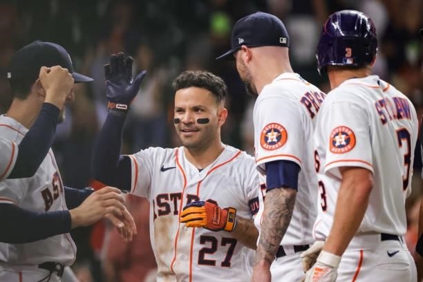 Jose Altuve of the Houston Astros hits a grand slam to defeat the Texas Rangers during the tenth inning winning 6-3 at Minute Maid Park on June 15,...