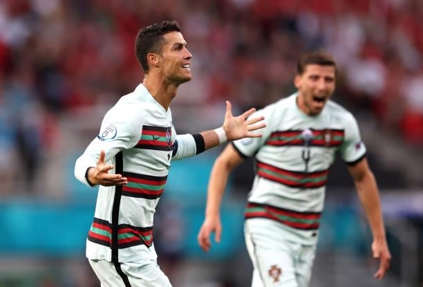 Cristiano Ronaldo of Portuagl celebrates scoring his sides third goal with team mate Ruben Dias during the UEFA Euro 2020 Championship Group F match...