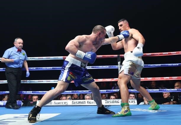 Paul Gallen punches Justis Huni during their Australian heavyweight title fight between Justis Huni and Paul Gallen at ICC Sydney on June 16, 2021 in...