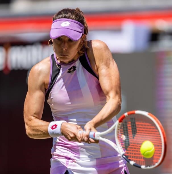 Alize Cornet of France hits a backhand against Bianca Andreescu of Canada in the women's singles second round match during day 5 of the bett1open at...