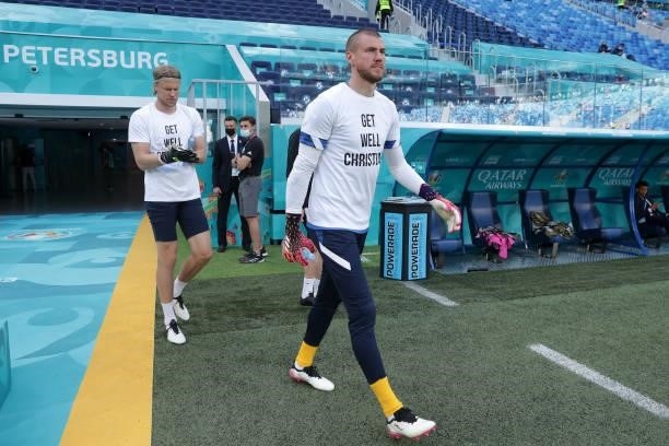 Jesse Joronen and Anssi Jaakkola of Finland enter the pitch for the warm up wearing 'Get well Christian Eriksen' shirts prior to the UEFA Euro 2020...