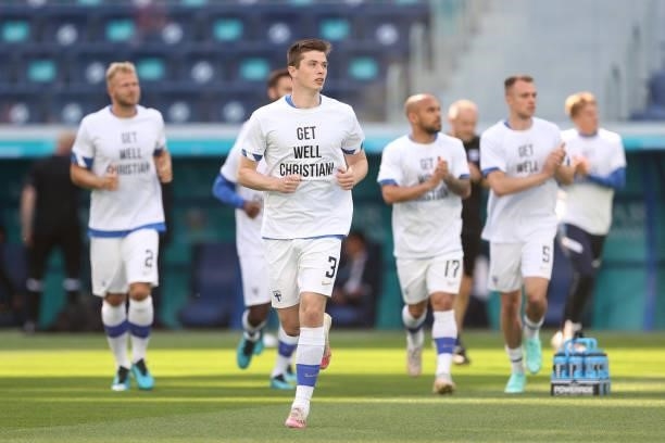 Daniel O'Shaughnessy of Finland warms up wearing a 'Get well Christian Eriksen' shirt prior to the UEFA Euro 2020 Championship Group B match between...
