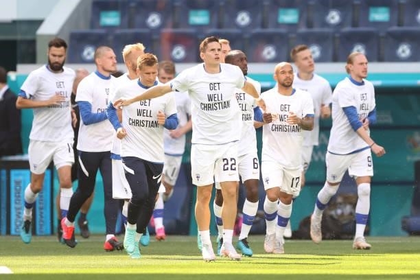 Jukka Raitala of Finland and team mates enter the pitch for the warm up wearing 'Get well Christian Eriksen' shirts prior to the UEFA Euro 2020...