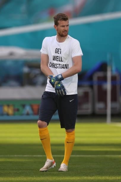 Lukas Hradecky of Finland warms up wearing a 'Get well Christian Eriksen' shirt prior to the UEFA Euro 2020 Championship Group B match between...