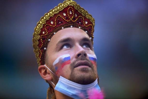 Russia fan wearing a hat and face paint looks on prior to the UEFA Euro 2020 Championship Group B match between Finland and Russia at Saint...