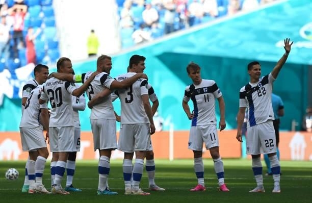 Jukka Raitala and Rasmus Schueller and team mates of Finland wait to form a huddle prior to the UEFA Euro 2020 Championship Group B match between...