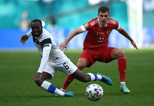 Glen Kamara of Finland battles for possession with Roman Zobnin of Russia during the UEFA Euro 2020 Championship Group B match between Finland and...