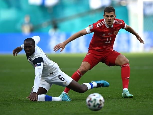 Glen Kamara of Finland battles for possession with Roman Zobnin of Russia during the UEFA Euro 2020 Championship Group B match between Finland and...
